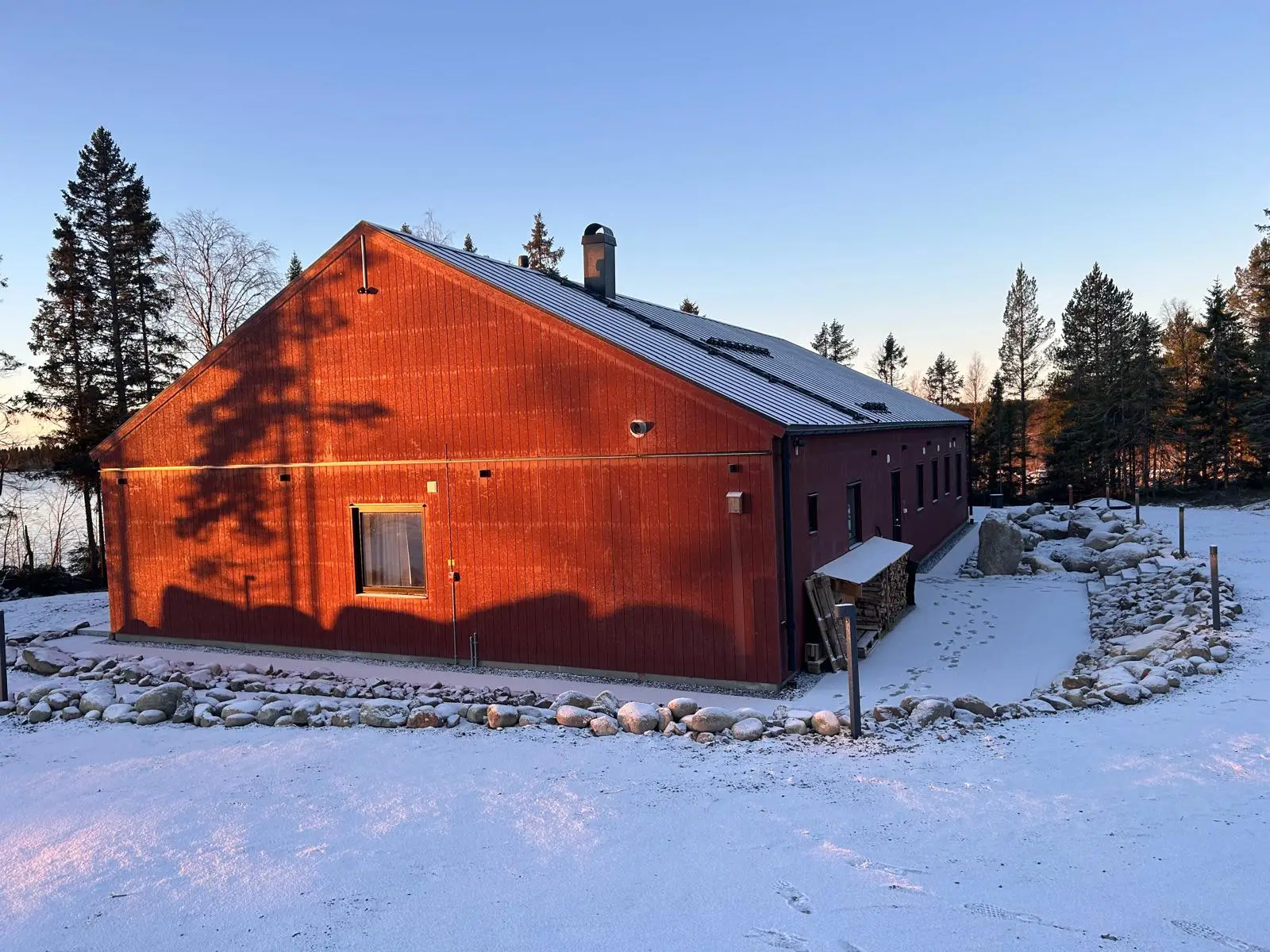 Red villa in snow at the forest edge